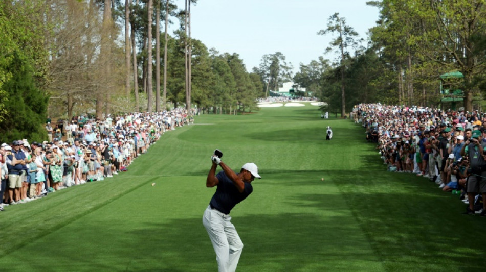 Spotlight on Woods provides respite for McIlroy at Masters