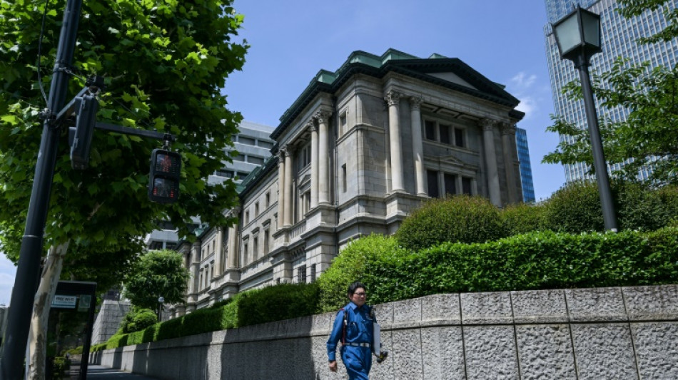 Bank of Japan holds rates, says to slow bond purchase taper