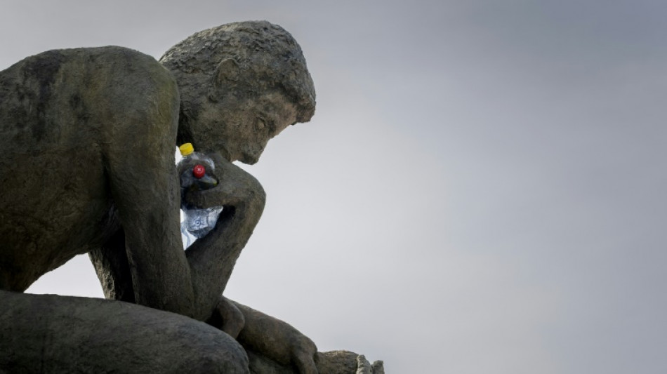A 'Thinker' drowns in plastic garbage as UN treaty talks open